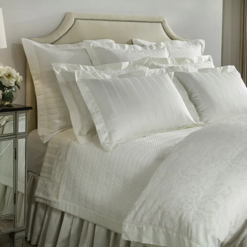 Home Treasures Plush 1000 Stripe ivory jacquard fitted sheet on styled bed.